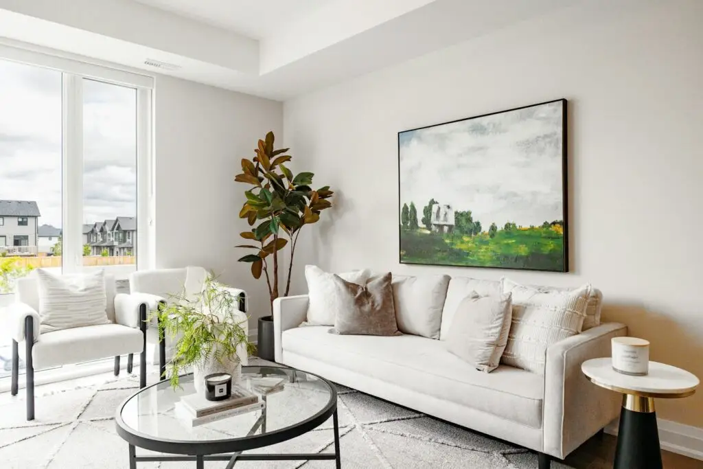 Modern living room with white sofa and artwork.